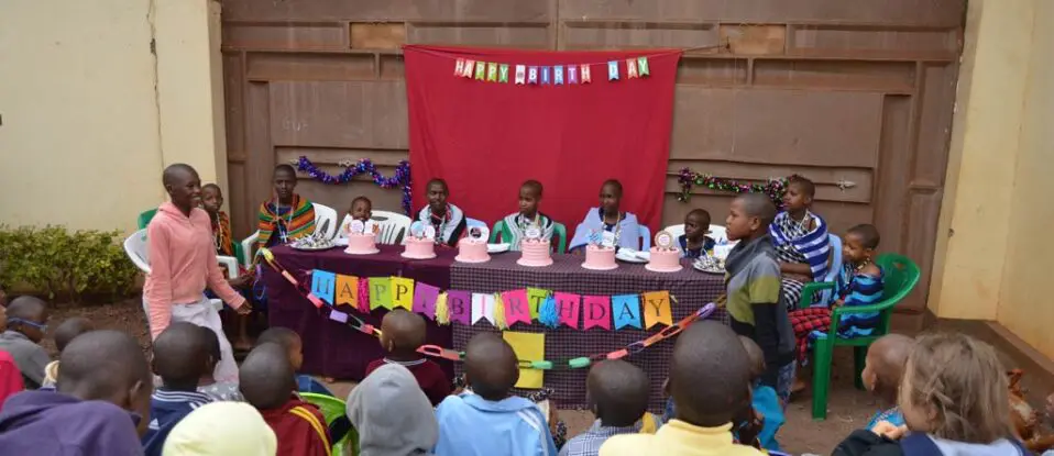 six girls sitting in front of their birthday cakes
