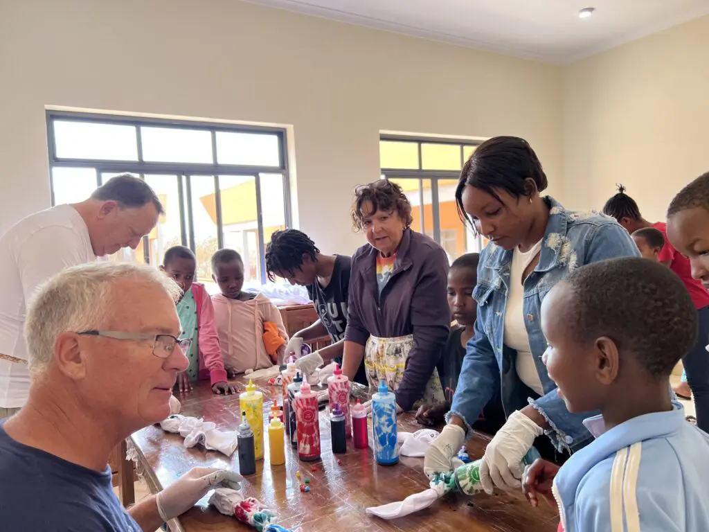 Volunteers work with the staff and the girls demostrating ways to give back.