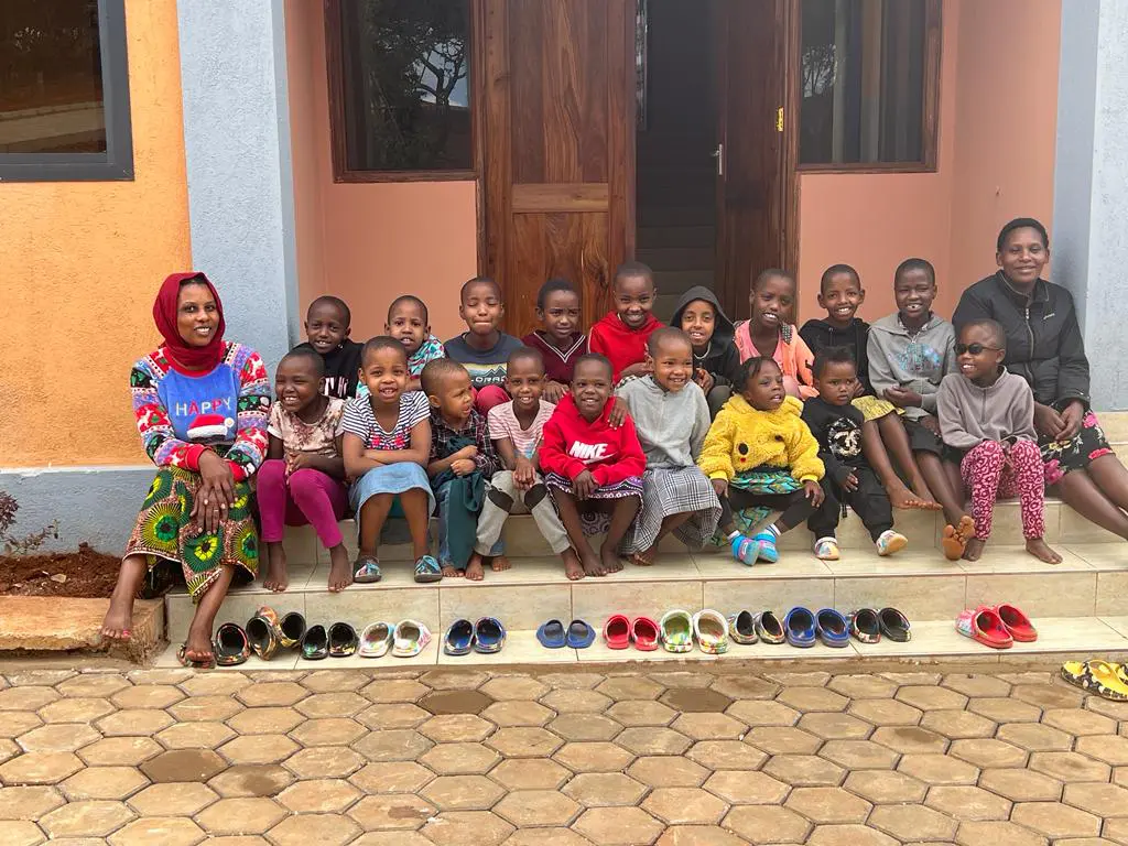 our youngest maasai girls sitting outside their new home with their house mothers