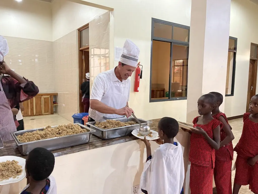 Greg helping with serving dinner to MGRC residents
