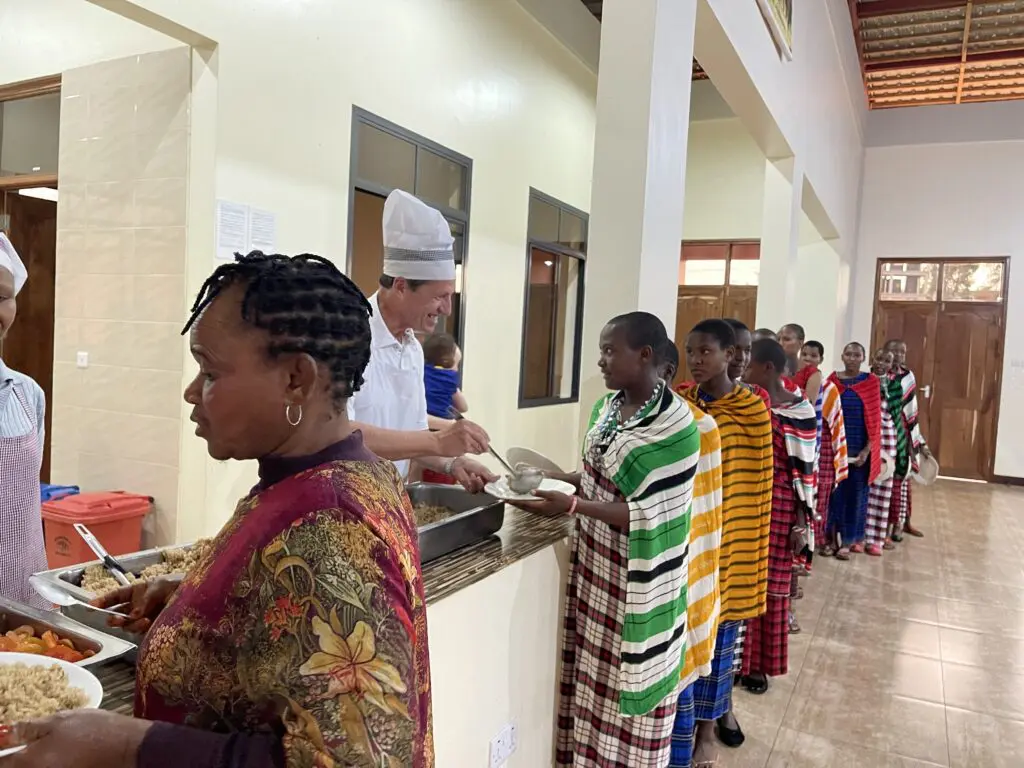 Greg helping with serving a meal at MGRC in Tanzania