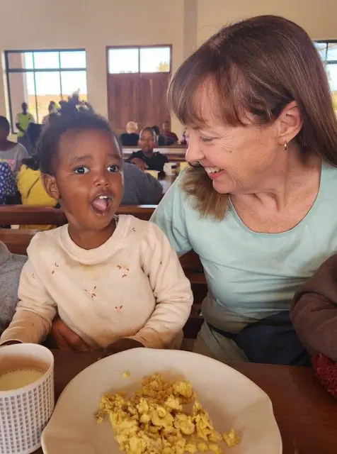 Sitting with Maasai girl at the breakfast table