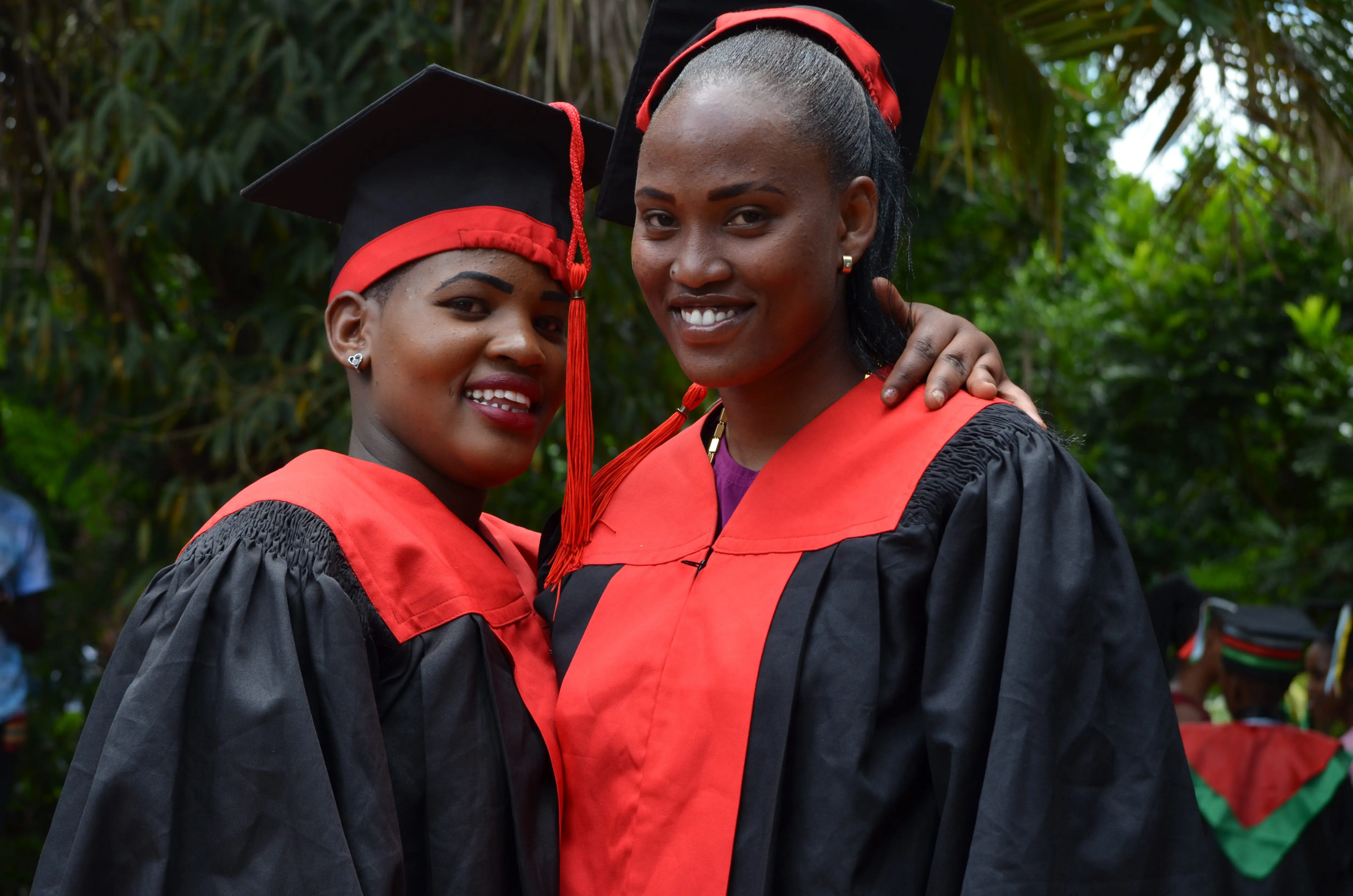 Yeyolai and Nemoipo in graduation caps and gowns