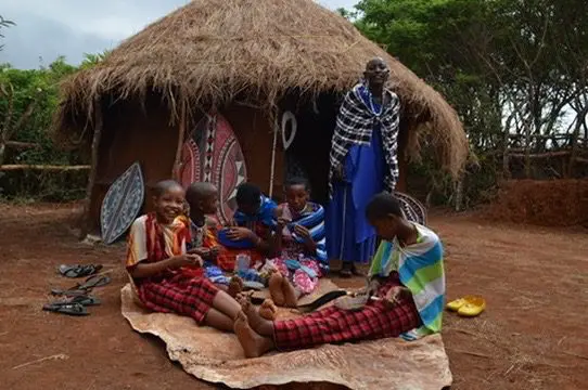 new maasai cultural center guide teaching maasai girls traditional bead making