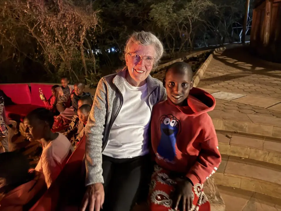 mgrc sponsor sitting with several maasai girls