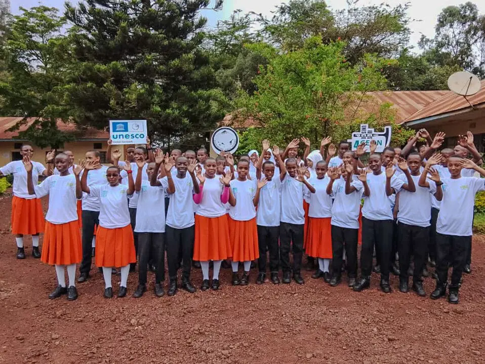 Students celebrating outdoors with signs at the African Culture Center