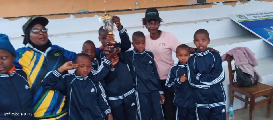 Team celebrating victory with trophy.