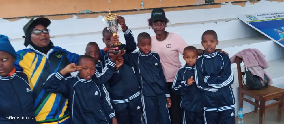 Team celebrating victory with trophy.