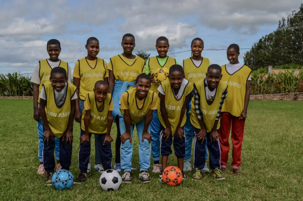 Group of children in soccer jerseys ready for fun and games.