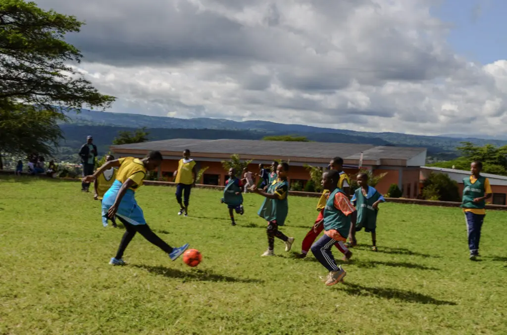 Children playing soccer on grass