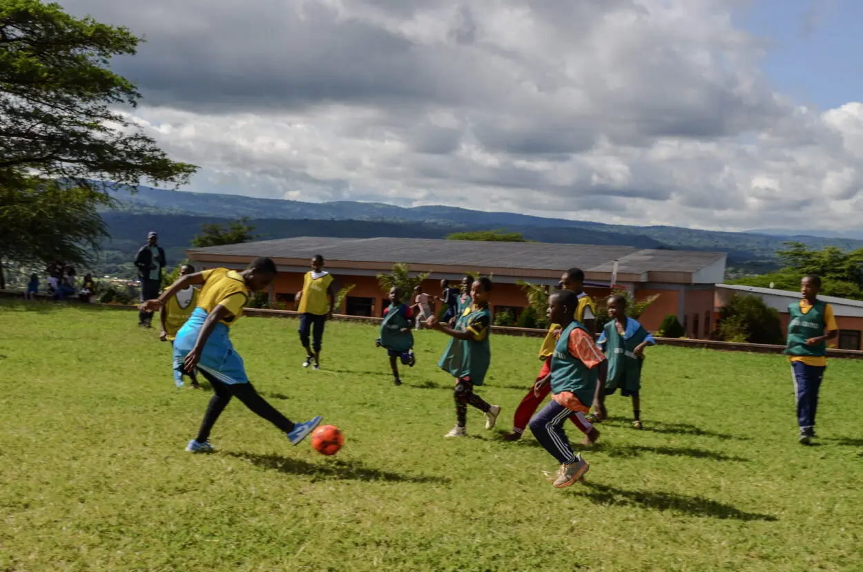 Children playing soccer on grass