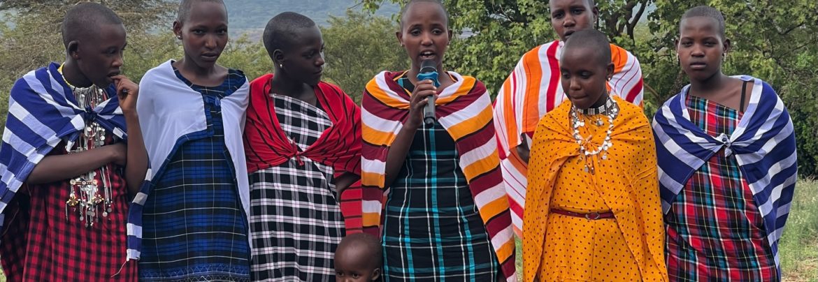 Momoi (center holding microphone) was able to use her language skills to translate her friends' testimonies at the Community Celebration. She speaks Maa, Swahili and English.