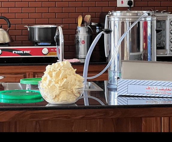 A pasteurizing machine on a kitchen counter displaying a bowl of butter.