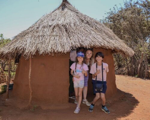 guests at the maasai culture center exploring a real life maasai boma