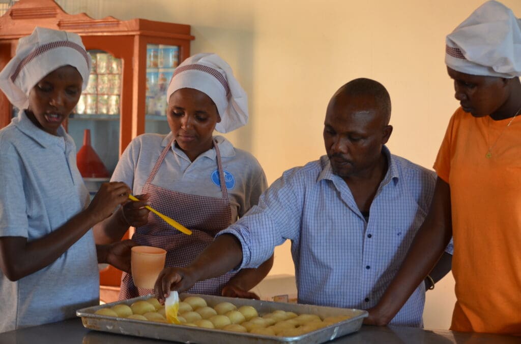 MGRC baking chef demostrating a technique to the vocational students.