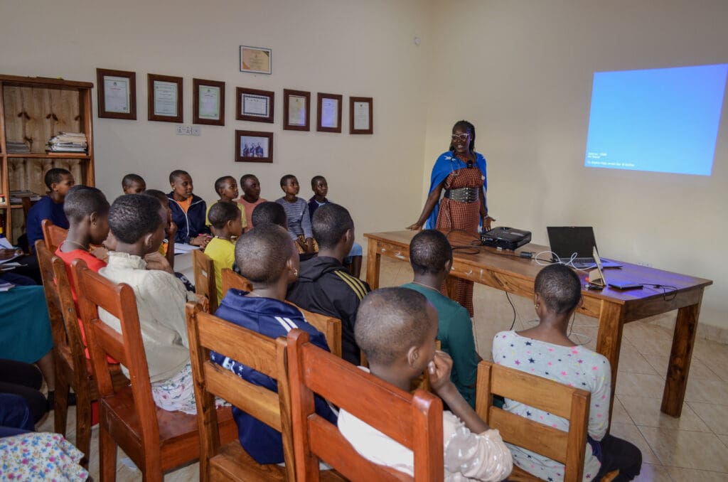 Classroom setting with students listening attentively as part of our Maasai WHO partnership.