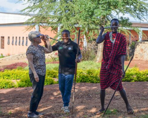 maasai culture center visitor learning to throw a spear like the massai warriors