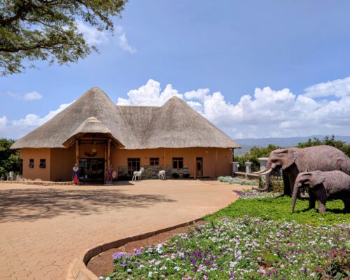 Maasai ecolodge with elephant statues and picturesque landscaping